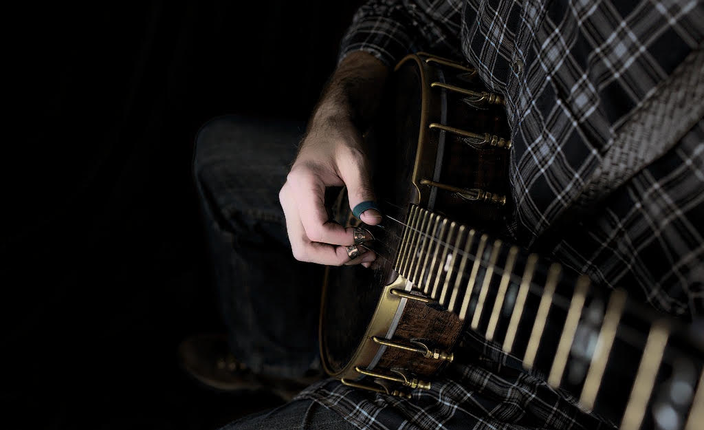 man playing the banjo. up close right-hand picture.