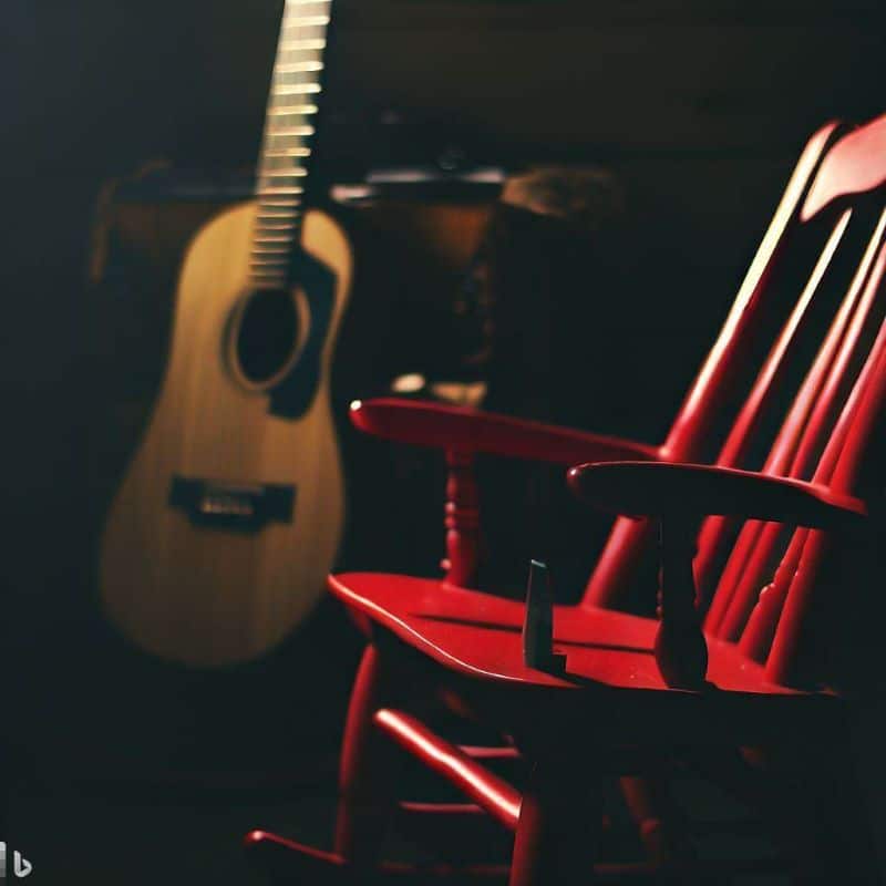 red rocking chair with guitar in background